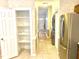 A hallway features a pantry, stainless steel refrigerator, and washer and dryer at 5500 Fortunes Ridge Dr # 82B, Durham, NC 27713