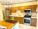 The kitchen has stainless steel appliances, wood cabinets, and light countertops at 5500 Fortunes Ridge Dr # 82B, Durham, NC 27713