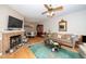 Cozy living room with a fireplace, hardwood floors, and ample natural light at 5500 Fortunes Ridge Dr # 82B, Durham, NC 27713
