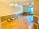 A living room with hardwood floors, a chandelier, and ceiling fan at 5500 Fortunes Ridge Dr # 82B, Durham, NC 27713