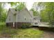 Back of house with a deck, nice yard and partial brick foundation at 5600 Treestand Ct, Garner, NC 27529