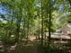 A natural setting with mature trees provides a tranquil backdrop for the backyard and pool area at 5600 Treestand Ct, Garner, NC 27529