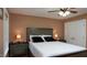 Bedroom features neutral carpet, large window, and ceiling fan at 5600 Treestand Ct, Garner, NC 27529