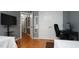 This bedroom has hardwood floors, a closet, desk, and television at 5600 Treestand Ct, Garner, NC 27529