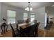 Dining room with wood flooring, a chandelier, and window views at 5600 Treestand Ct, Garner, NC 27529