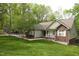 Charming home featuring a brick facade, landscaped front yard, and inviting front porch at 5600 Treestand Ct, Garner, NC 27529