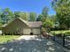 Spacious garage and driveway with a manicured lawn and partial fencing at 5600 Treestand Ct, Garner, NC 27529