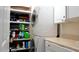 Functional laundry area with stacked washer/dryer and storage shelves at 5600 Treestand Ct, Garner, NC 27529