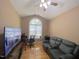 This living room area has hardwood floors, vaulted ceilings, a large window, and a ceiling fan at 5600 Treestand Ct, Garner, NC 27529