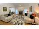 Cozy living room with stone fireplace, neutral furniture, and view into dining room at 5600 Treestand Ct, Garner, NC 27529
