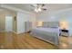 This main bedroom features hardwood floors, a tray ceiling with ceiling fan, and neutral paint at 5600 Treestand Ct, Garner, NC 27529