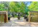 Wooden deck with furniture, a fenced yard, and green trees at 5860 Andover Dr, Graham, NC 27253