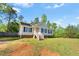 Charming home with white siding, black shutters, and well-maintained landscaping at 5860 Andover Dr, Graham, NC 27253