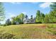Charming single-story home with a large front yard and a detached storage building at 5860 Andover Dr, Graham, NC 27253