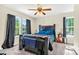Spacious main bedroom with two windows, carpet, ceiling fan, and neutral paint at 5860 Andover Dr, Graham, NC 27253