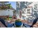 View of the backyard and house exterior from the wooden deck, furnished with chairs and a table with flowers at 612 Spring Meadow Dr, Durham, NC 27713