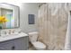 This is a bathroom with a large mirror, toilet and a shower curtain with a geometric design at 612 Spring Meadow Dr, Durham, NC 27713