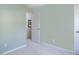 This bedroom has neutral walls and carpeting with a doorway to another room at 612 Spring Meadow Dr, Durham, NC 27713