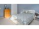 Bedroom features a light blue color scheme and includes a dresser and double door closet at 612 Spring Meadow Dr, Durham, NC 27713