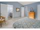 Light blue bedroom showcases a doorway to the en suite bathroom and walk-in closet at 612 Spring Meadow Dr, Durham, NC 27713