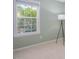 Small empty room has light green walls with a large window for lots of natural light at 612 Spring Meadow Dr, Durham, NC 27713