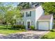 Charming two-story home with light blue siding, lush landscaping, and an attached garage, showcasing curb appeal at 612 Spring Meadow Dr, Durham, NC 27713