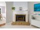 Cozy fireplace with brick surround and a white mantel at 612 Spring Meadow Dr, Durham, NC 27713