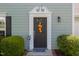 Elegant black front door with decorative trim, enhancing the entrance with charm and style at 612 Spring Meadow Dr, Durham, NC 27713
