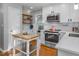 Charming kitchen features stainless appliances, subway tile backsplash and butcher block topped island at 612 Spring Meadow Dr, Durham, NC 27713