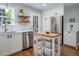 Bright kitchen features stainless appliances, stylish floating shelves, and a butcher block topped island at 612 Spring Meadow Dr, Durham, NC 27713