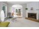 Open living room with a fireplace and view into the dining room, perfect for entertaining at 612 Spring Meadow Dr, Durham, NC 27713