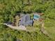 Stunning aerial view of the home with a pool, lush landscaping and surrounded by mature trees at 6824 Wood Forest Dr, Cary, NC 27519