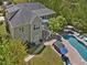 Aerial view of the backyard featuring a swimming pool, hot tub, lush landscaping, patio, and elevated deck at 6824 Wood Forest Dr, Cary, NC 27519