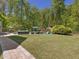 Large backyard featuring a pool, hot tub, slide, lounge chairs, and a manicured lawn for outdoor enjoyment at 6824 Wood Forest Dr, Cary, NC 27519