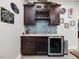 Home bar area with custom cabinetry, wine rack, beverage fridge and stylish backsplash at 6824 Wood Forest Dr, Cary, NC 27519