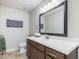 Bathroom featuring a large mirror, and a vanity with storage at 6824 Wood Forest Dr, Cary, NC 27519
