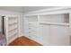 Built-ins featuring shelving, drawers, and cabinets on hardwood floors at 6824 Wood Forest Dr, Cary, NC 27519