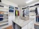 Walk-in closet featuring custom built-in storage and an island with granite countertop at 6824 Wood Forest Dr, Cary, NC 27519