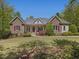 Charming stone-accented home with a well-manicured lawn and a inviting front porch at 6824 Wood Forest Dr, Cary, NC 27519