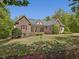 Lovely home featuring stone accents, a pristine lawn, and attractive curb appeal at 6824 Wood Forest Dr, Cary, NC 27519