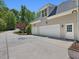 Exterior featuring three-car garage, concrete driveway and neutral siding at 6824 Wood Forest Dr, Cary, NC 27519