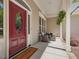 Cozy front porch featuring a red door, comfortable chairs, and a 'welcome' mat at 6824 Wood Forest Dr, Cary, NC 27519