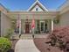 Inviting front porch with stone steps, comfortable seating, and charming decor at 6824 Wood Forest Dr, Cary, NC 27519