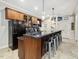 Spacious kitchen with dark wood cabinets, granite counters, and a large island with bar seating at 6824 Wood Forest Dr, Cary, NC 27519
