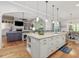 Open concept kitchen and living area with large island and modern appliances at 6824 Wood Forest Dr, Cary, NC 27519