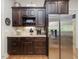 Kitchen area featuring stainless steel refrigerator, granite countertops, and custom cabinetry at 6824 Wood Forest Dr, Cary, NC 27519