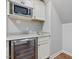 Kitchenette featuring a microwave, stainless steel wine fridge, granite countertops at 6824 Wood Forest Dr, Cary, NC 27519