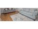 Bright living room featuring two sofas and a colorful patterned rug on hardwood floors at 6824 Wood Forest Dr, Cary, NC 27519