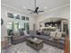 Open concept living area with large sectional sofa, island seating, and access to the outside at 6824 Wood Forest Dr, Cary, NC 27519