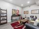 Living room with musical instruments, a wooden shelf, and unique artwork, perfect for relaxation at 6824 Wood Forest Dr, Cary, NC 27519
